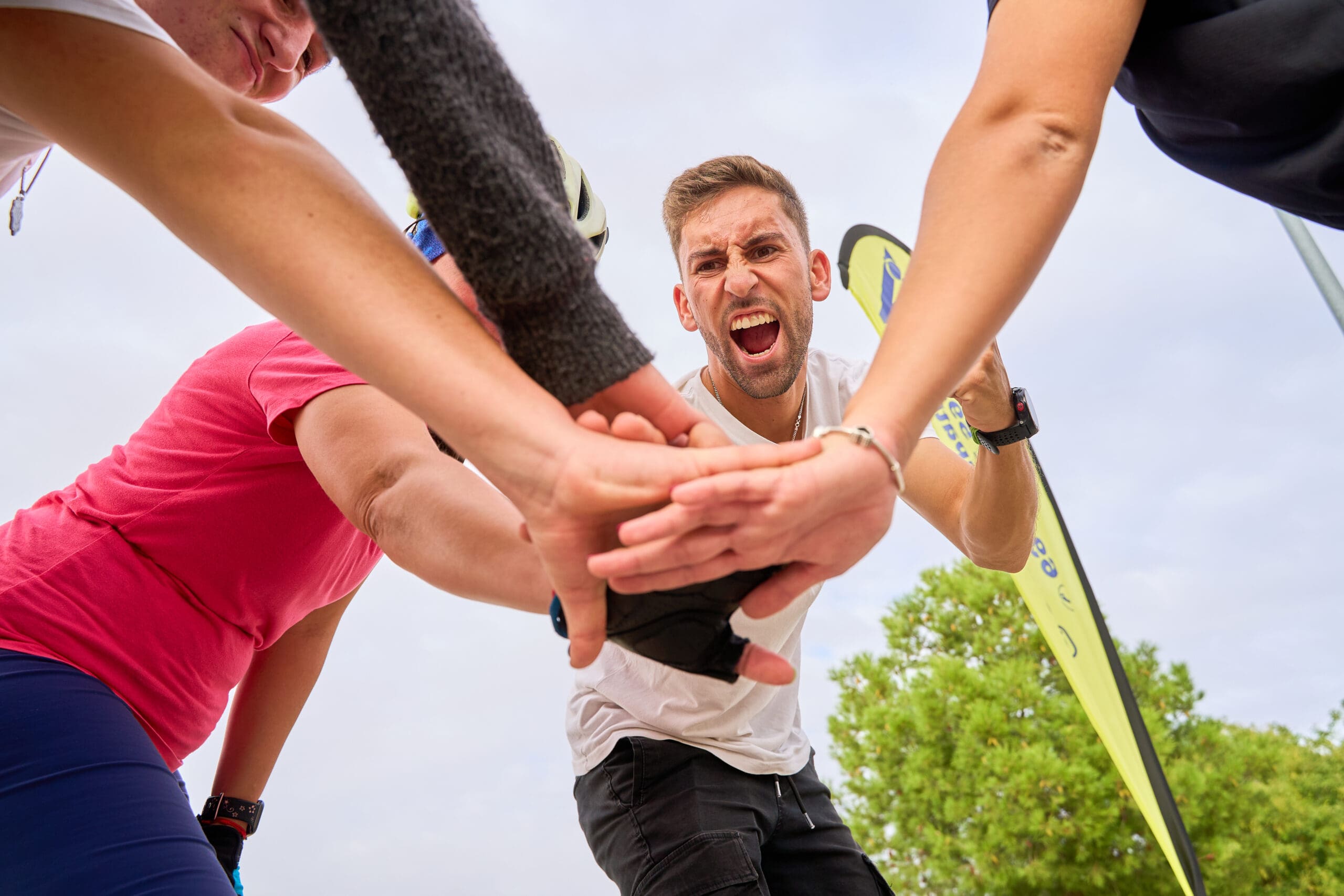 Rollerblading group sharing a motivational team cheer outdoors